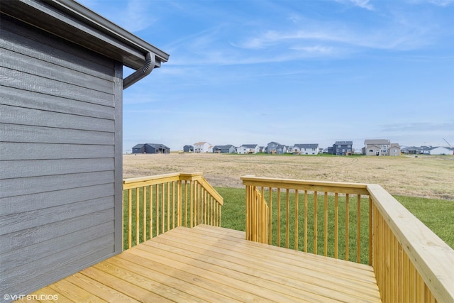 wooden terrace featuring a lawn