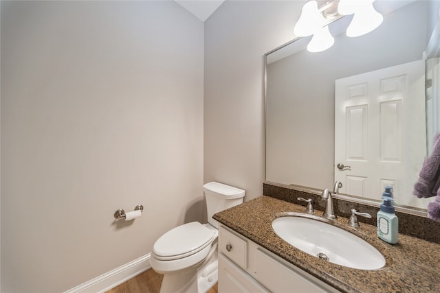 bathroom featuring hardwood / wood-style floors, vanity, and toilet