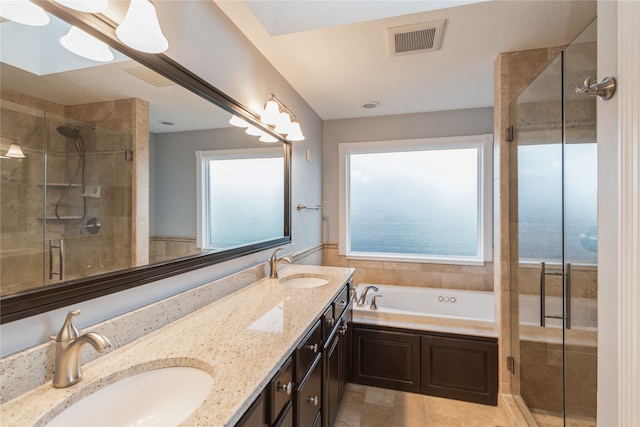 bathroom with plus walk in shower, vanity, and tile patterned flooring