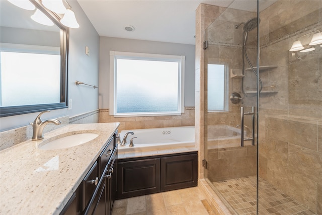 bathroom with tile patterned floors, vanity, and shower with separate bathtub