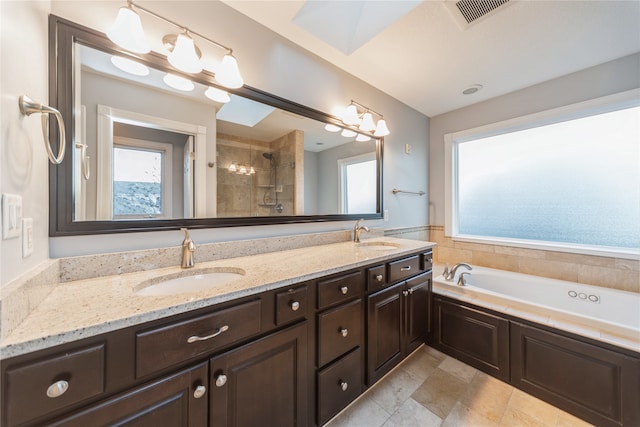 bathroom featuring vanity and separate shower and tub