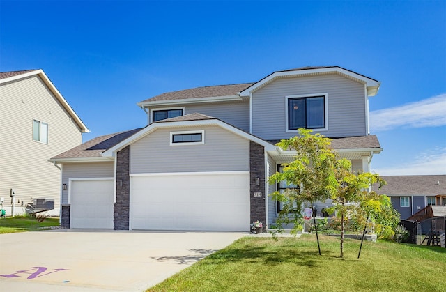 view of front of house featuring a garage, central AC unit, and a front lawn