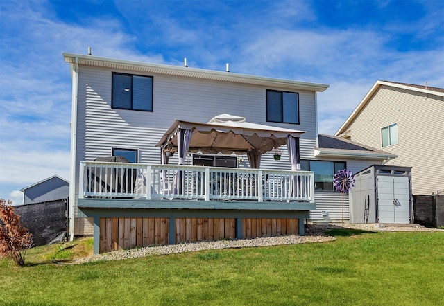 back of property with a storage shed, a gazebo, a yard, and a deck