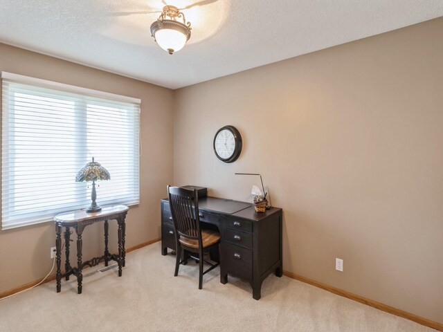 office area with light carpet and a textured ceiling