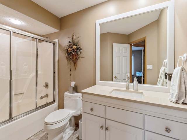 full bathroom with enclosed tub / shower combo, vanity, tile patterned flooring, and toilet