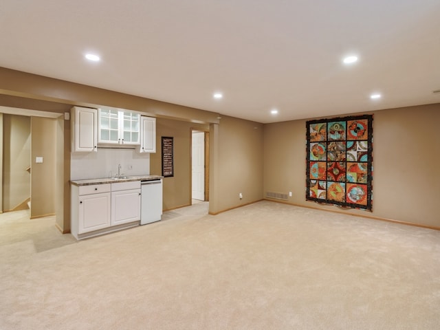 interior space featuring indoor wet bar and light colored carpet