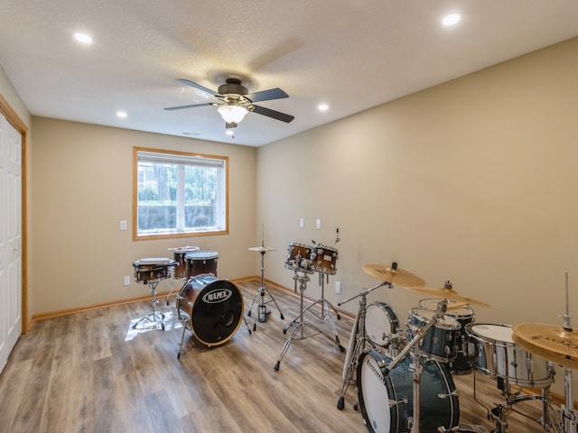 interior space with light hardwood / wood-style flooring, ceiling fan, and a textured ceiling