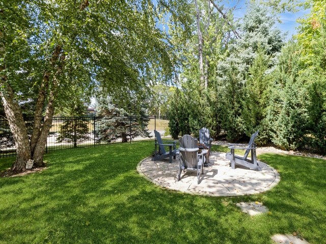 view of yard with a fire pit and a patio area