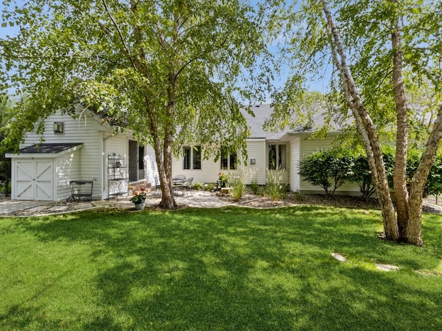 back of property featuring a lawn and a patio area