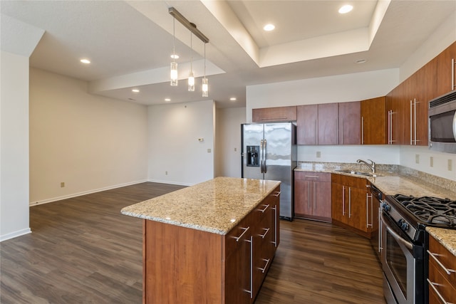 kitchen featuring decorative light fixtures, a kitchen island, dark hardwood / wood-style flooring, and appliances with stainless steel finishes