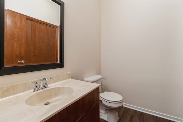 bathroom featuring hardwood / wood-style floors, vanity, and toilet