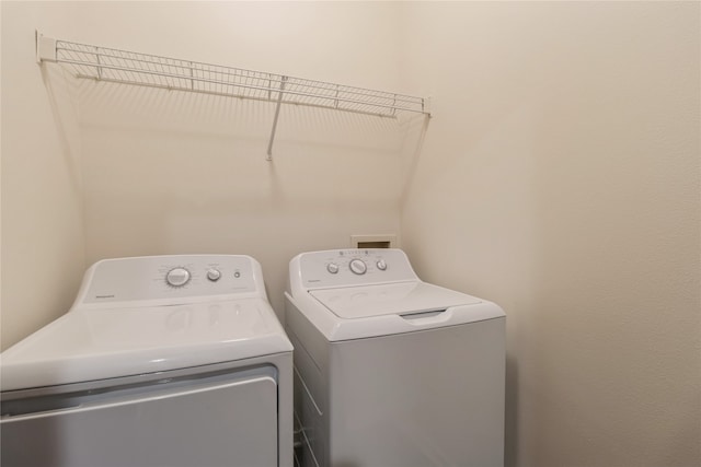 washroom with independent washer and dryer