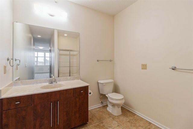 bathroom featuring tile patterned floors, vanity, toilet, and a shower with door