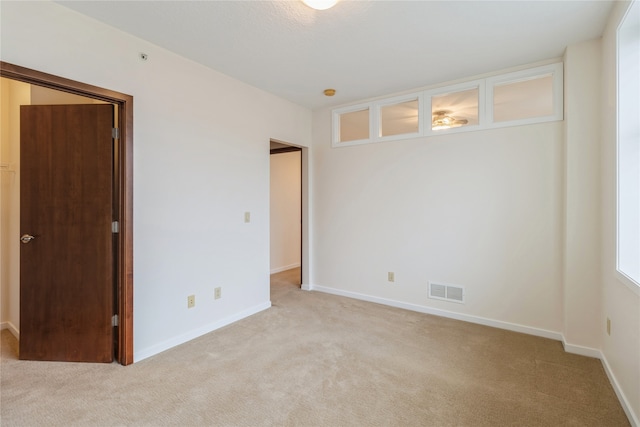 empty room with light colored carpet