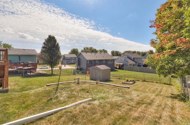 view of yard with a wooden deck and a storage unit