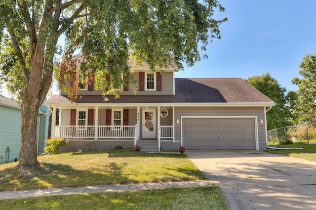 view of front facade featuring a front yard, a garage, and covered porch