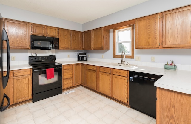 kitchen featuring black appliances and sink