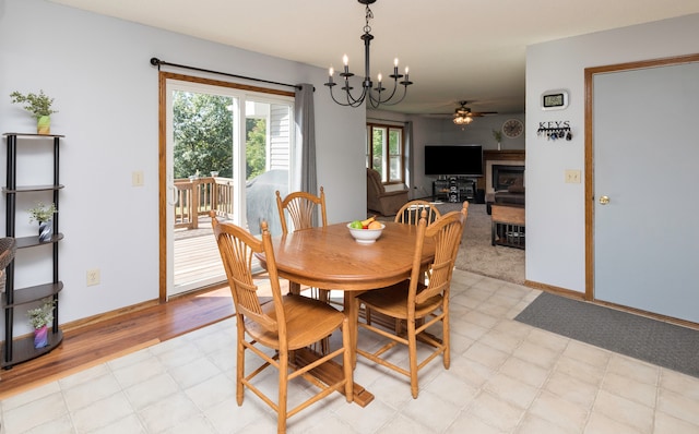 dining room featuring ceiling fan with notable chandelier