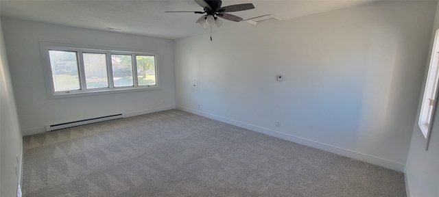 carpeted spare room featuring baseboard heating and ceiling fan