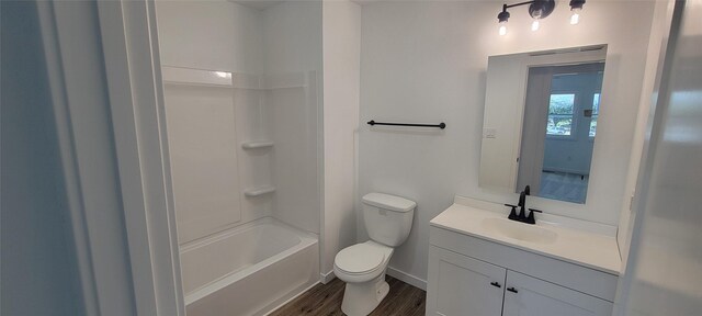 full bathroom with wood-type flooring, vanity, toilet, and shower / bath combination