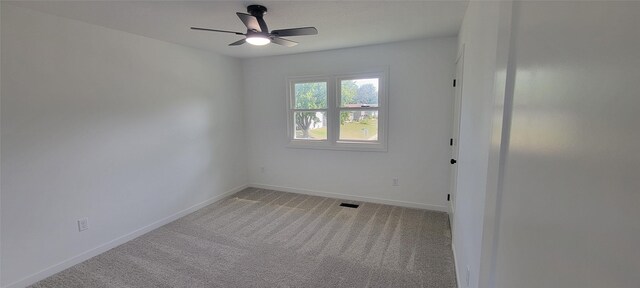 carpeted empty room featuring ceiling fan