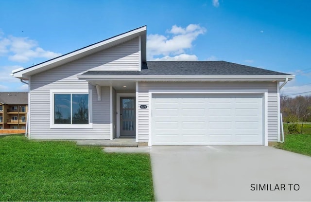 view of front of property with a front yard and a garage