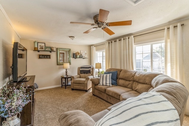 living room featuring light carpet, a textured ceiling, ceiling fan, and crown molding