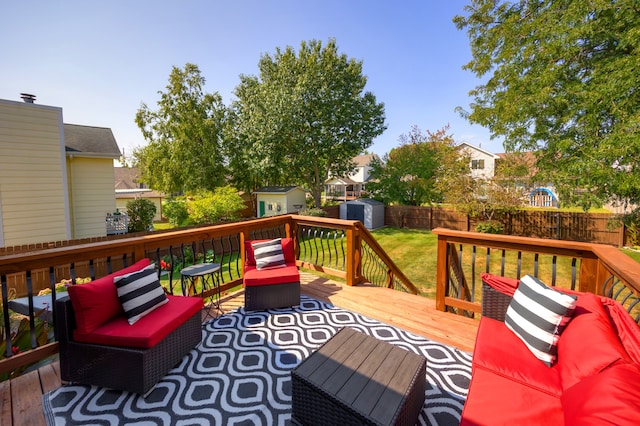 wooden terrace with a storage shed and a yard