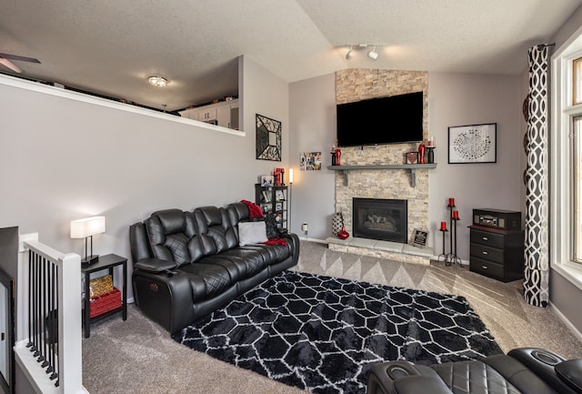 living room with ceiling fan, carpet floors, lofted ceiling, and a fireplace