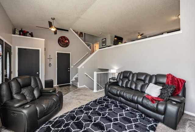 carpeted living room with a textured ceiling and lofted ceiling