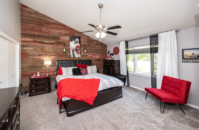 bedroom featuring wood walls, vaulted ceiling, ceiling fan, and light colored carpet