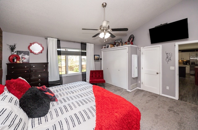 bedroom with ceiling fan, light colored carpet, and vaulted ceiling