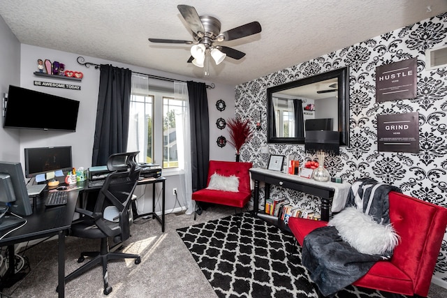 carpeted home office with ceiling fan and a textured ceiling