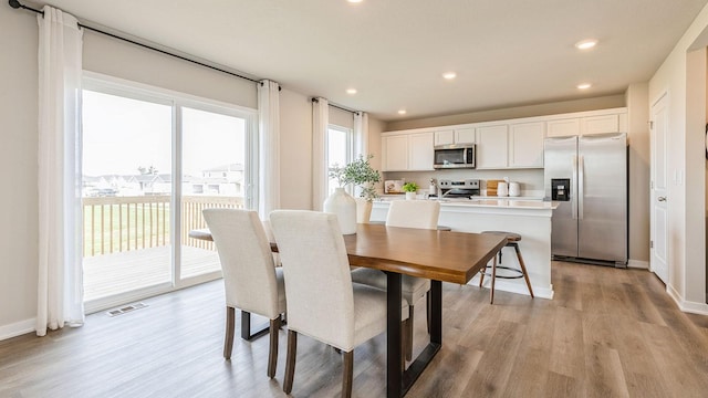 dining area with light hardwood / wood-style floors