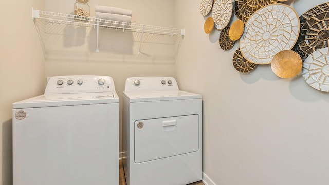 clothes washing area with washing machine and dryer