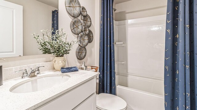 full bathroom featuring vanity, shower / tub combo, and toilet