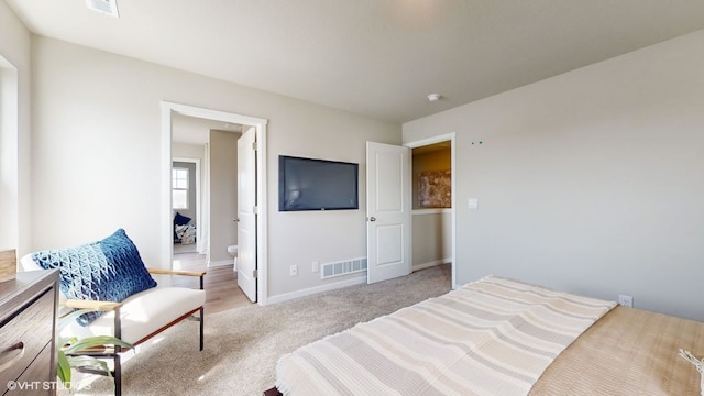 carpeted bedroom featuring ensuite bathroom