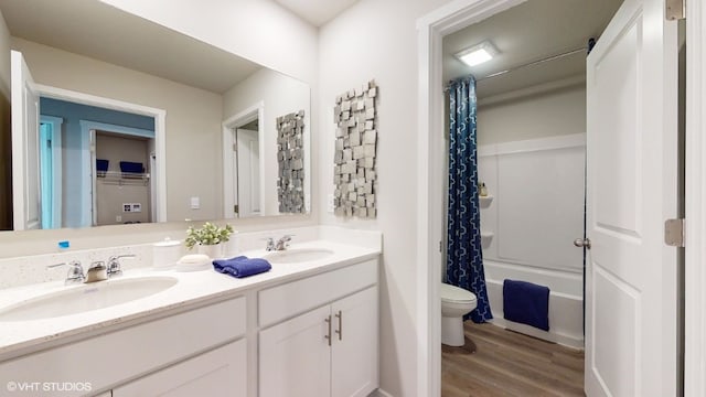 full bathroom featuring vanity, hardwood / wood-style flooring, toilet, and shower / bathtub combination with curtain