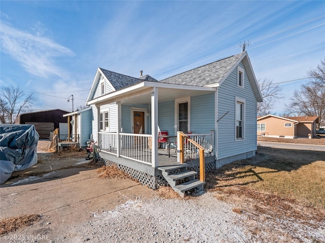 bungalow-style home featuring a carport and covered porch