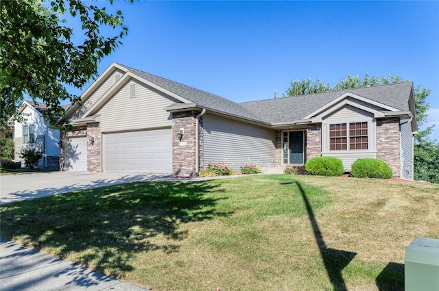 ranch-style home featuring a garage and a front lawn