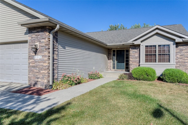 view of front of home featuring a garage and a front lawn