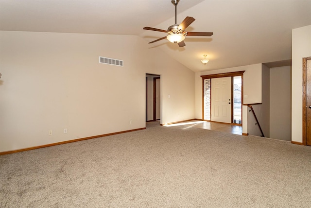 spare room with lofted ceiling, ceiling fan, and carpet flooring