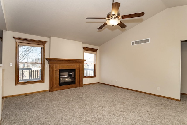 unfurnished living room with lofted ceiling, light carpet, and a healthy amount of sunlight