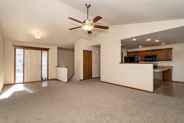 unfurnished living room featuring lofted ceiling, light carpet, and ceiling fan