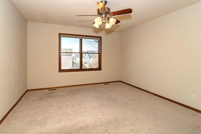 empty room featuring carpet floors and ceiling fan