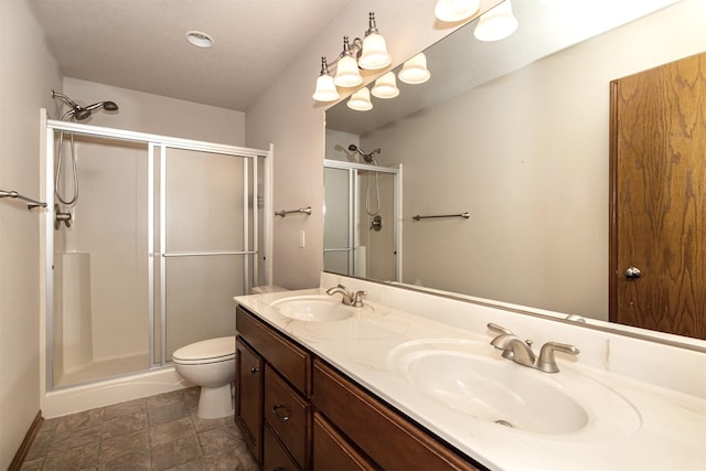 bathroom with vanity, an enclosed shower, and toilet