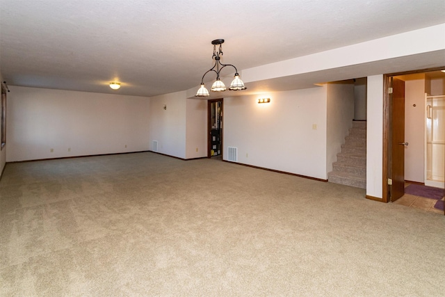 unfurnished room featuring light carpet