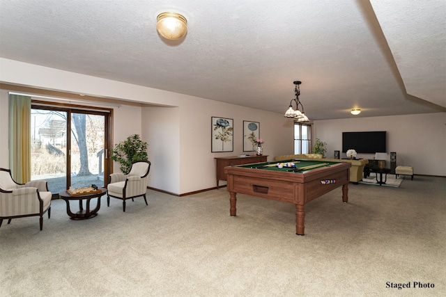 rec room featuring light colored carpet, billiards, and a textured ceiling