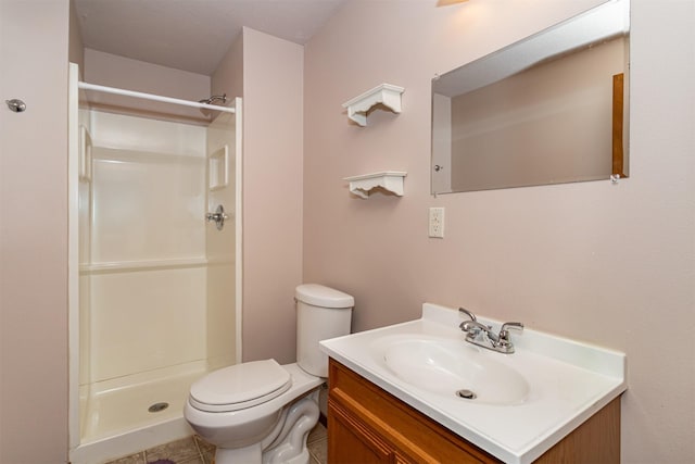 bathroom with tile patterned floors, vanity, toilet, and a shower