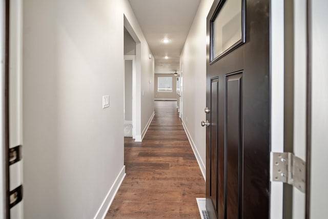 hallway with dark hardwood / wood-style flooring